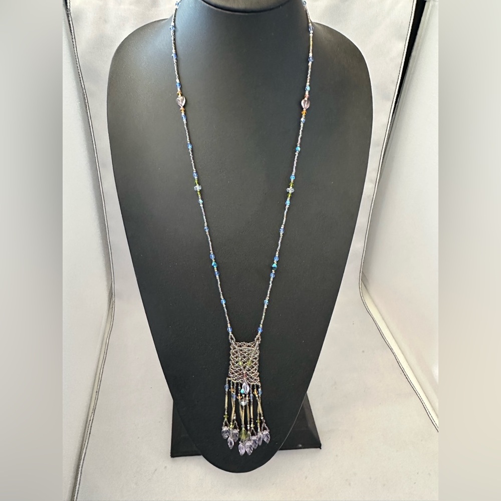 Handcrafted beaded amulet bag necklace in light blue purple and orange colors